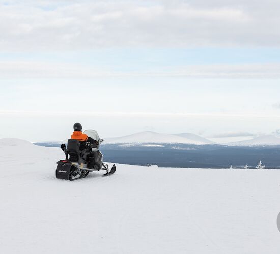 Snowmobile tour through the Finnish wilderness
