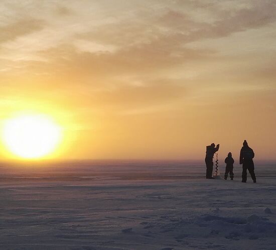 Ice fishing on the frozen sea